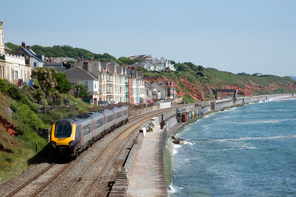 Passenger train traveling along a coastal railway.