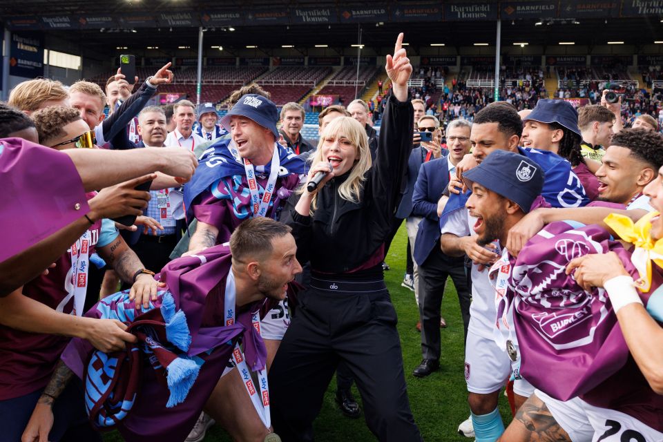 Natasha Bedingfield singing on the pitch after Burnley's promotion.