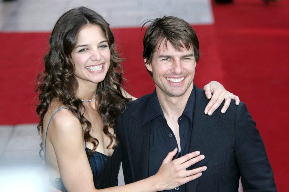 Tom Cruise and Katie Holmes embracing at a premiere.