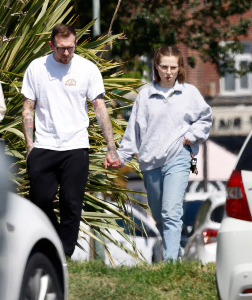 Jeremy Forrest and Jessica Amos holding hands on a street.