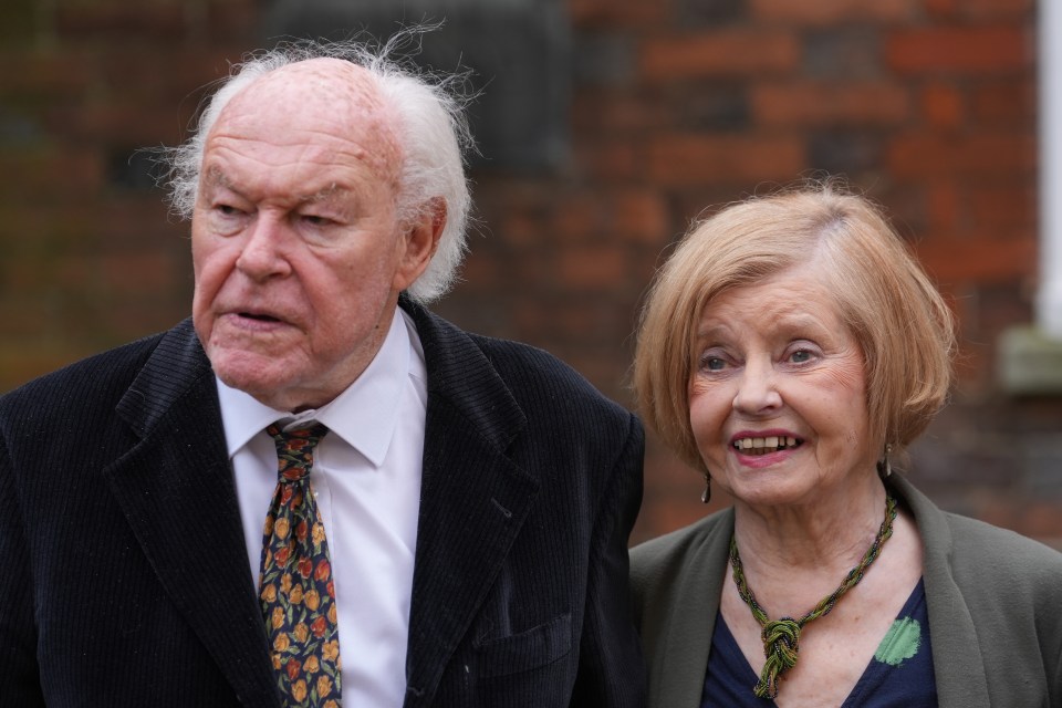 Timothy West and Prunella Scales leaving a house.
