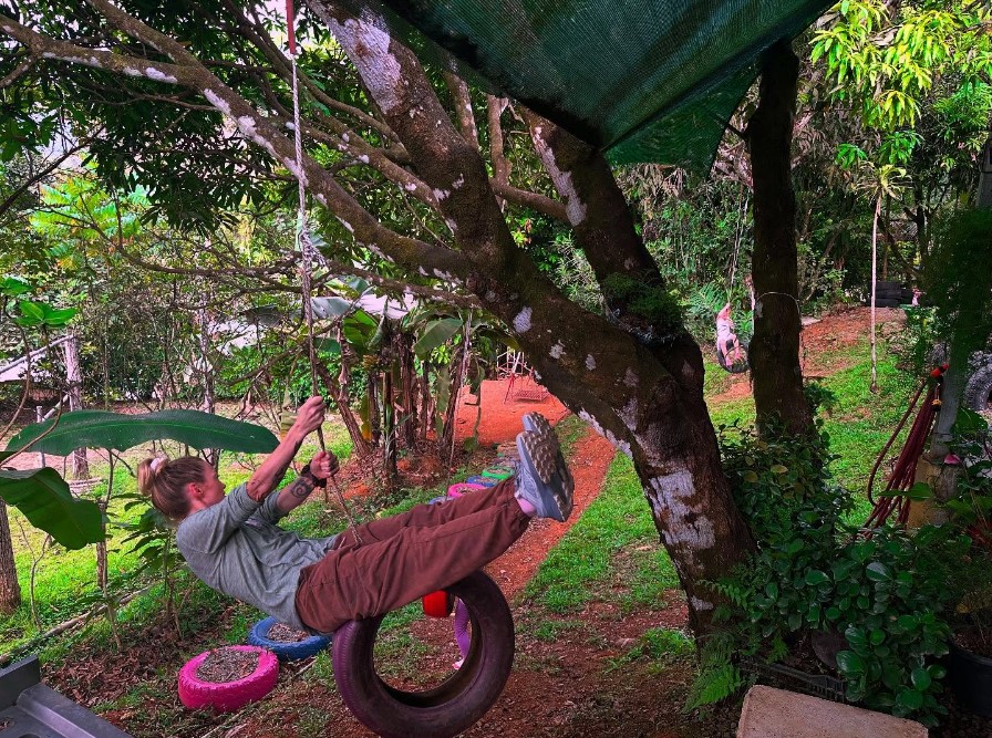 Woman swinging on tire swing in Costa Rica.