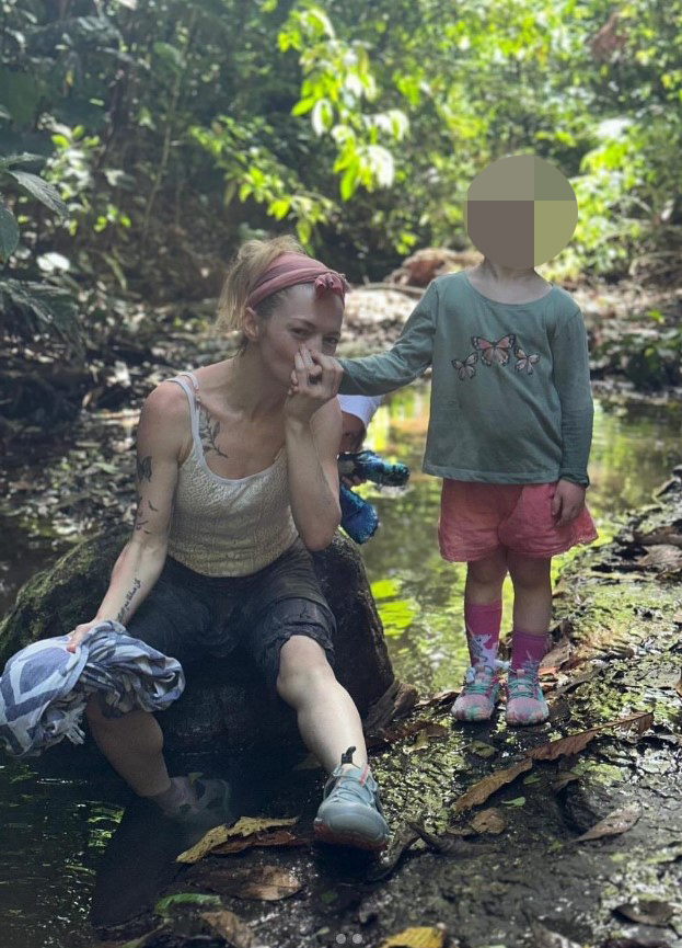 Hannah Spearritt with her child by a stream in Costa Rica.