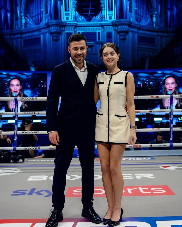 Photo of a man and woman standing in a boxing ring.