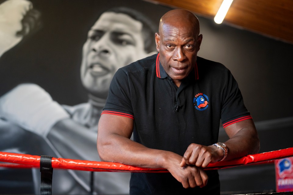 Frank Bruno leaning on boxing ring ropes.