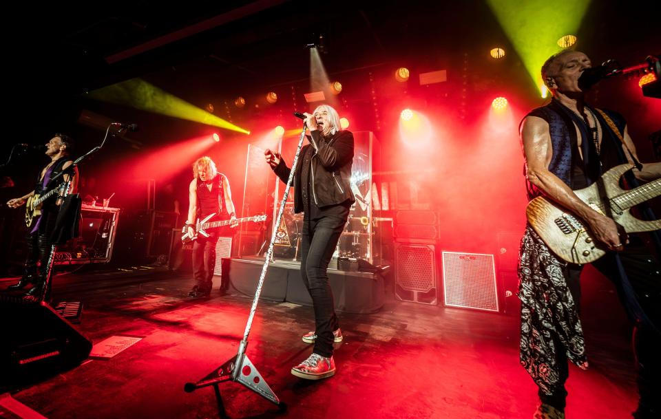 Def Leppard performing live on stage.