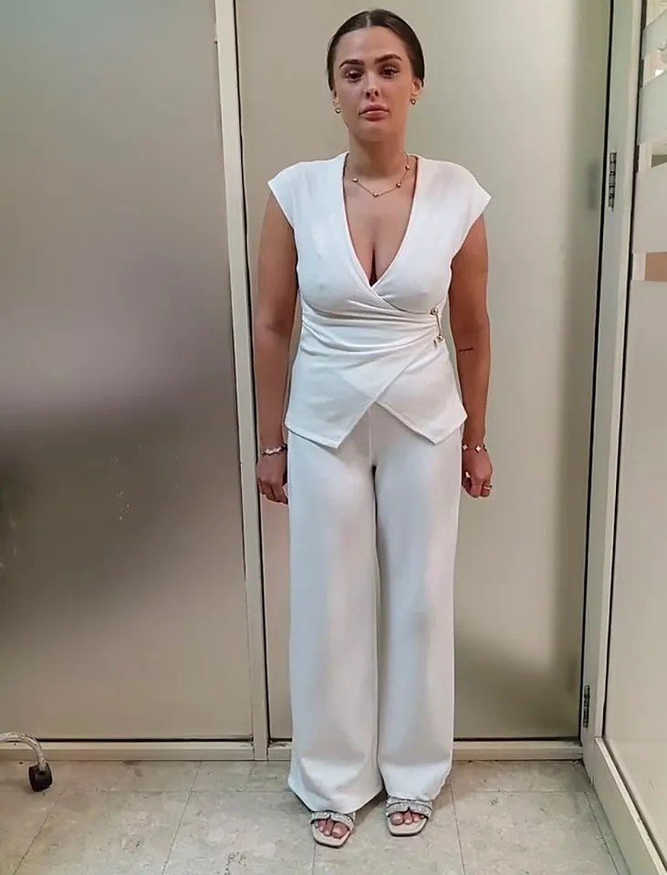 Woman in a white pantsuit.