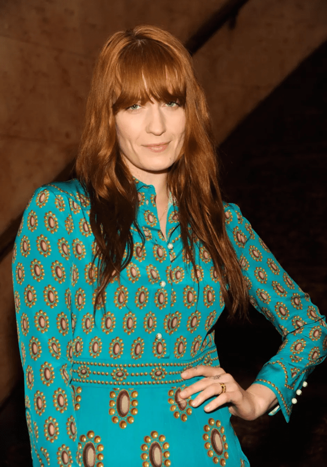 Florence Welch in a teal patterned dress.