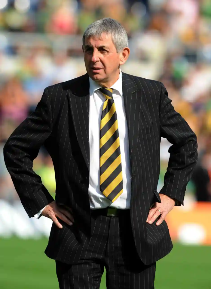 A man in a pinstripe suit and striped tie.
