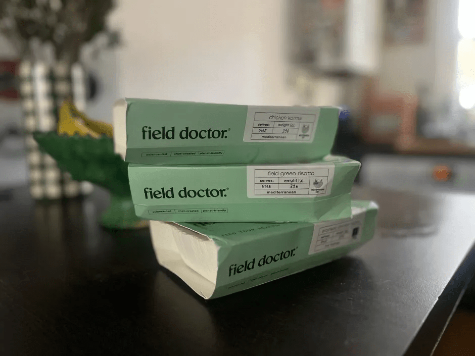 Three Field Doctor meal containers stacked on a table.