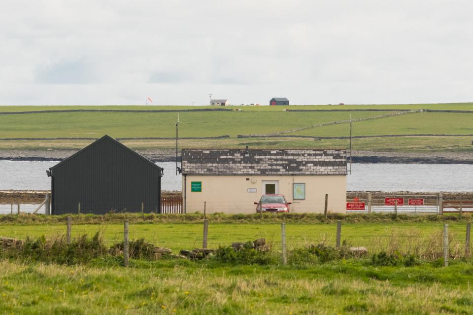 Westray Airport buildings and a car.