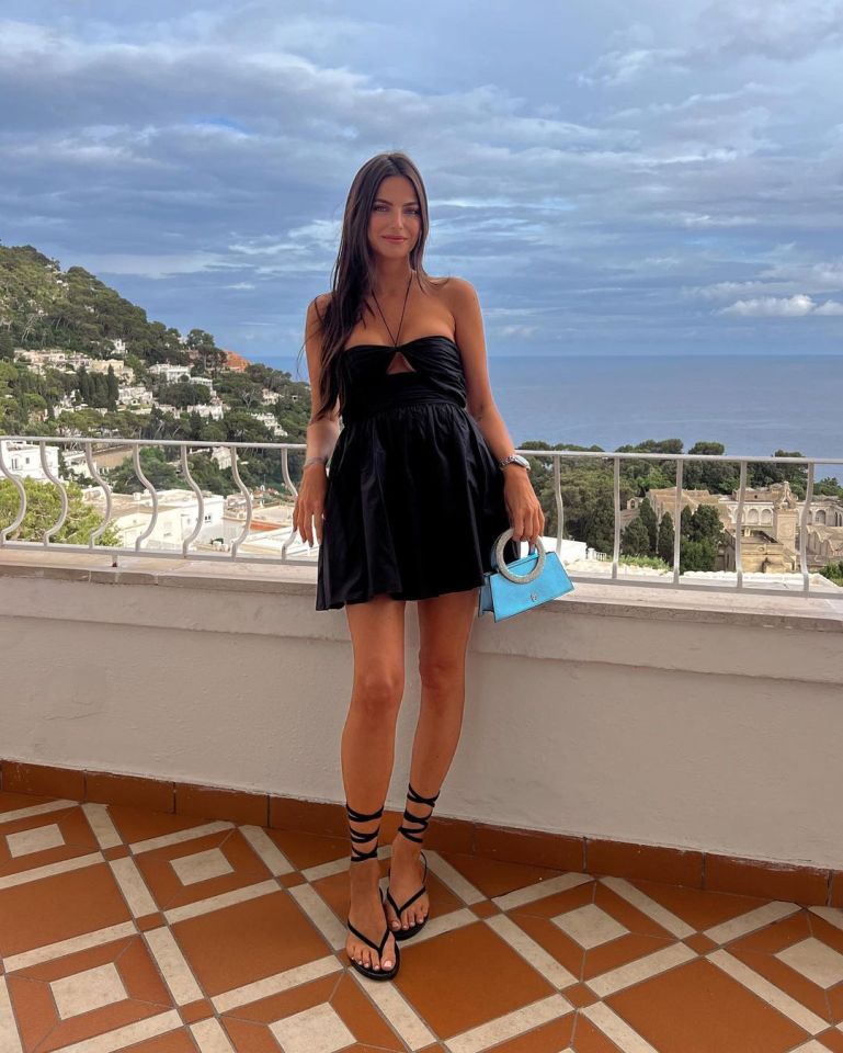Kelly Piquet in a black dress.