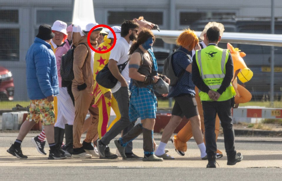 Men in various costumes boarding a private jet.