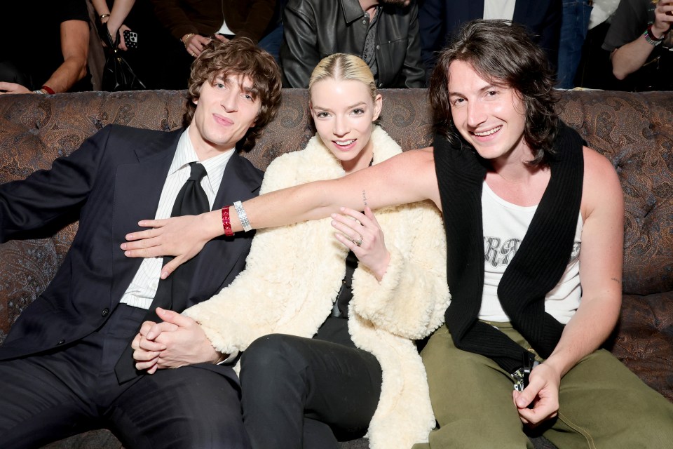 Malcolm McRae, Anya Taylor-Joy, and a guest at an event.
