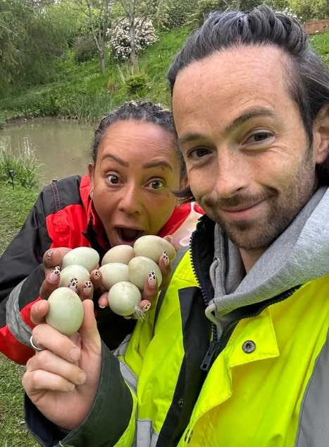 Mel B and partner holding a group of eggs.