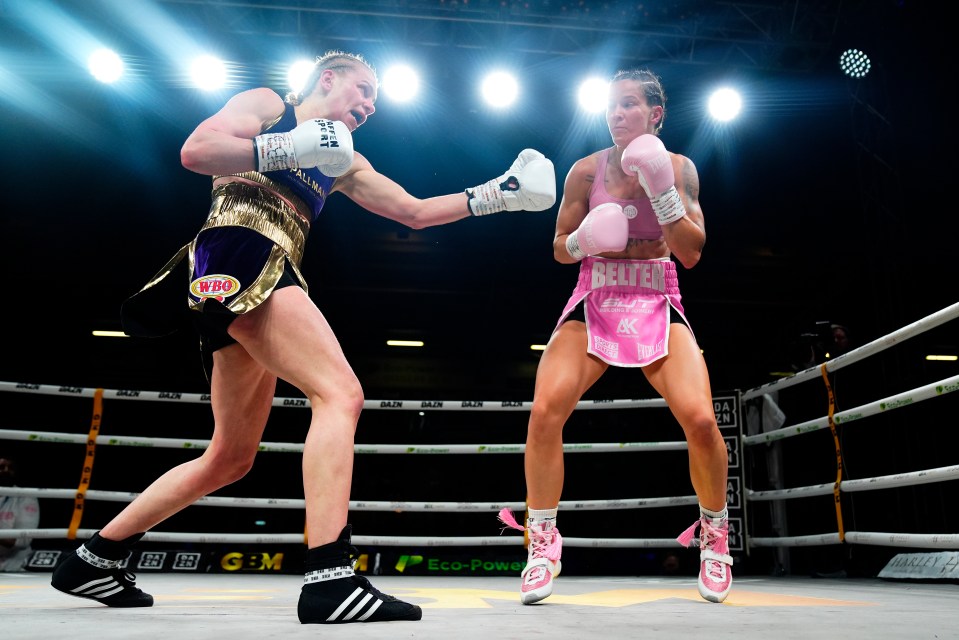 Two female boxers in a boxing match.