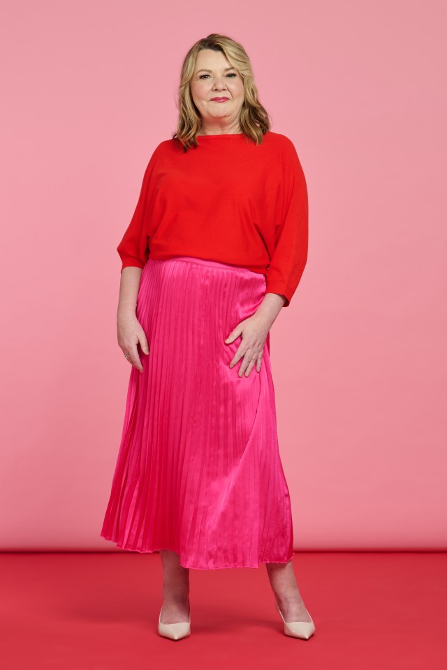 Woman in red top and pink pleated skirt.