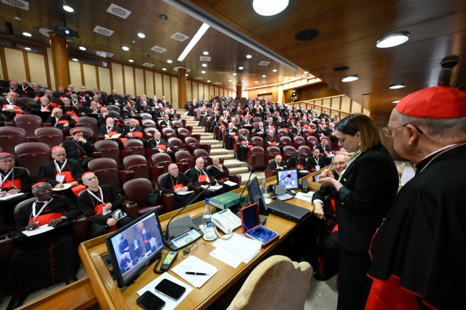 Cardinals at a general congregation ceremonially destroying the Fisherman's Ring and lead seal of Pope Francis.