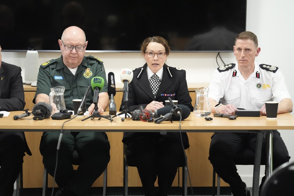 Three emergency service officials at a press conference.