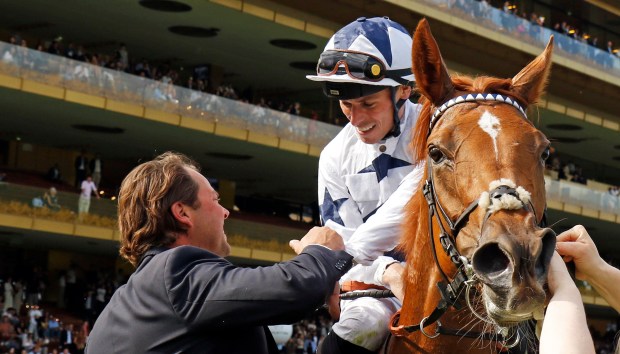 Jockey Kieran Shoemark and a man in a suit with the horse &quot;Shes Perfect&quot; after a race disqualification.