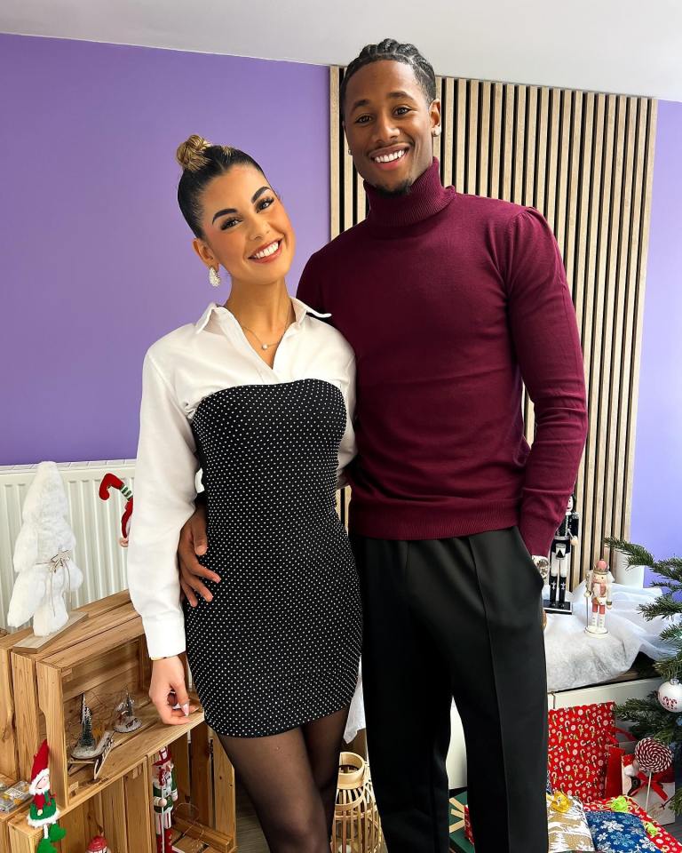 A TikTok-famous goalkeeper and his Miss Universe girlfriend pose together.