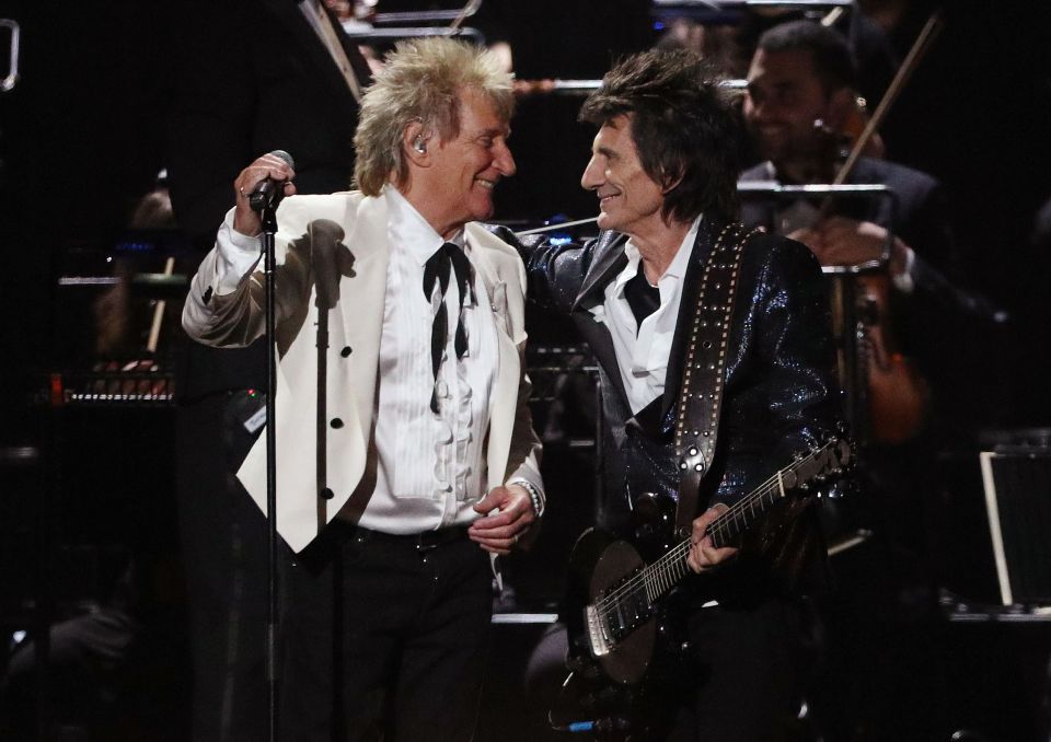 Rod Stewart and Ronnie Wood performing on stage.