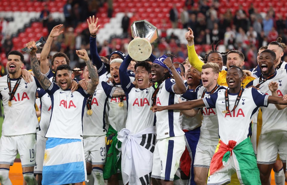 Tottenham Hotspur players celebrating a victory with the UEFA Europa League trophy.