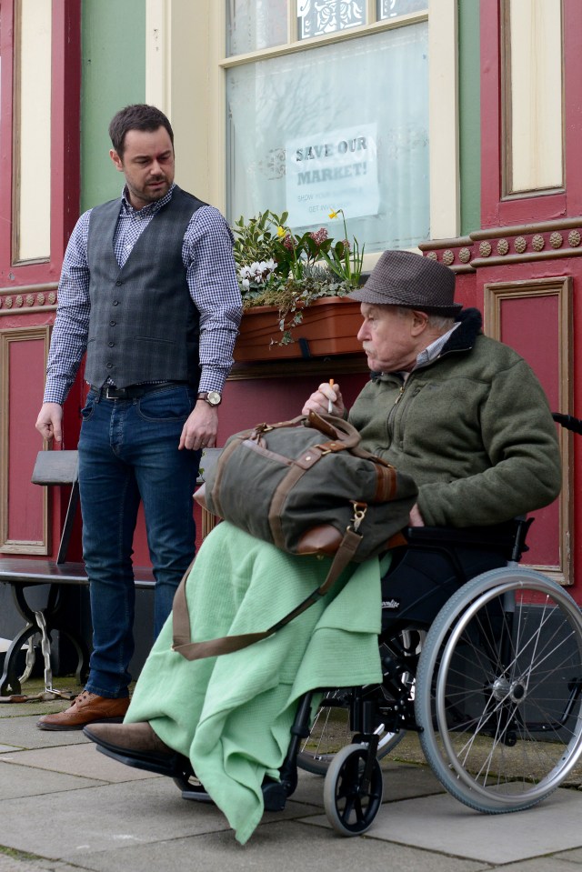 Mick Carter talking to Stan Carter, who is in a wheelchair.