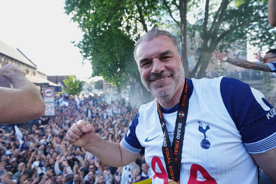 Ange Postecoglou, Tottenham Hotspur head coach, celebrates on a parade bus.