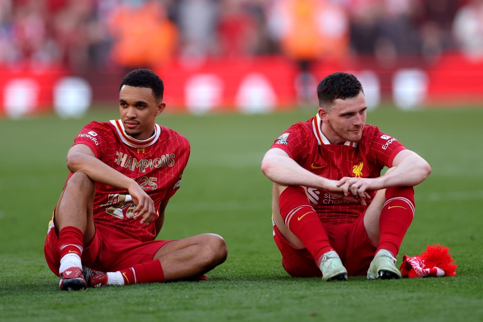 Trent Alexander-Arnold and Andrew Robertson of Liverpool sitting on the field.