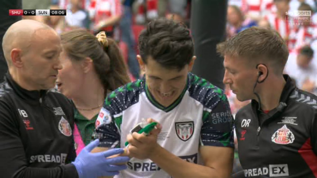 A soccer player receives medical attention on the field.