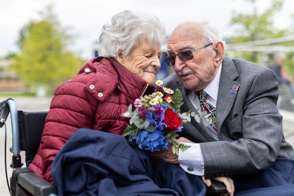 An elderly couple, both RAF veterans, share a kiss on the 80th anniversary of VE Day.