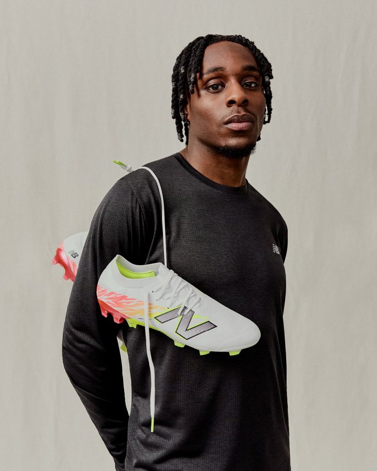 Jeremie Frimpong holding New Balance football boots.