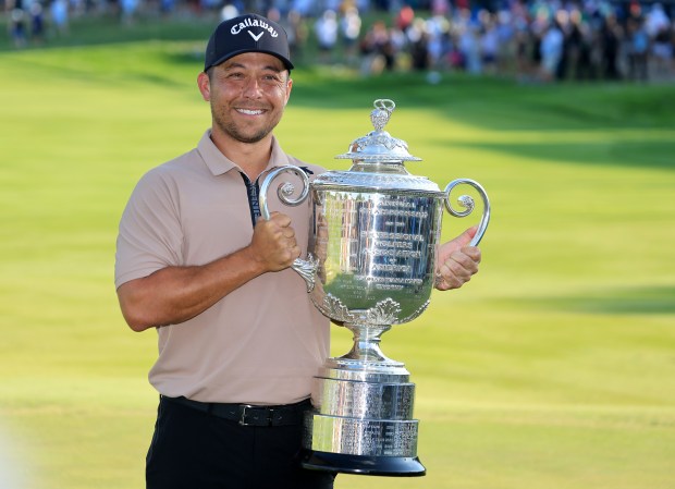 Xander Schauffele holding the Wanamaker Trophy.