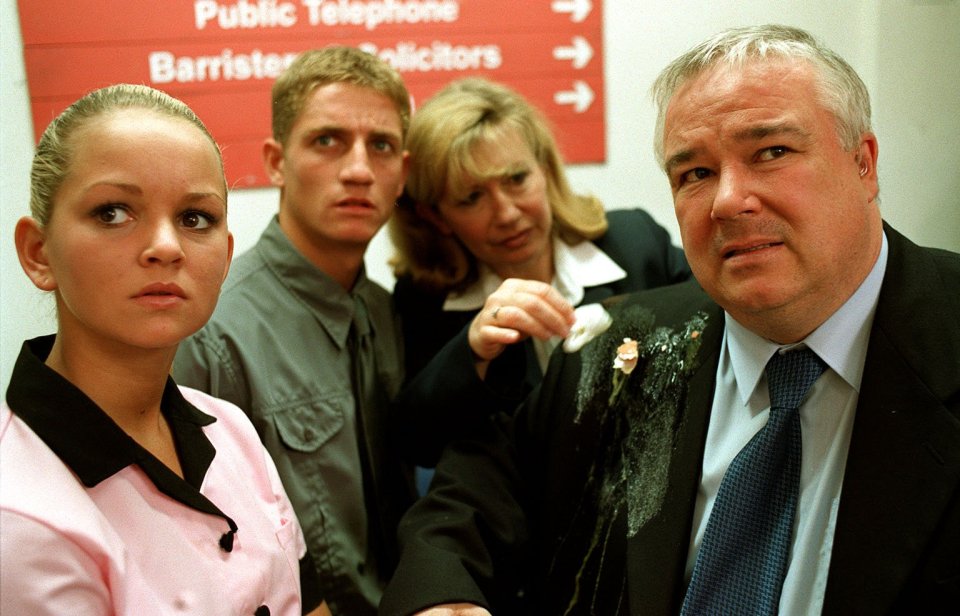 Still image from Brookside episode 2415 showing Sinbad humiliated outside a courtroom.