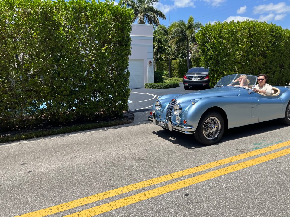 Brooklyn and Nicola Beckham driving a vintage Jaguar XK140.