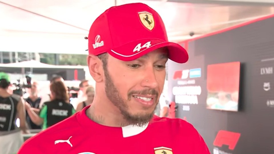 Lewis Hamilton in a red Ferrari hat.