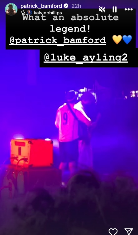 Photo of two people on stage, one wearing a jersey with the number 9.