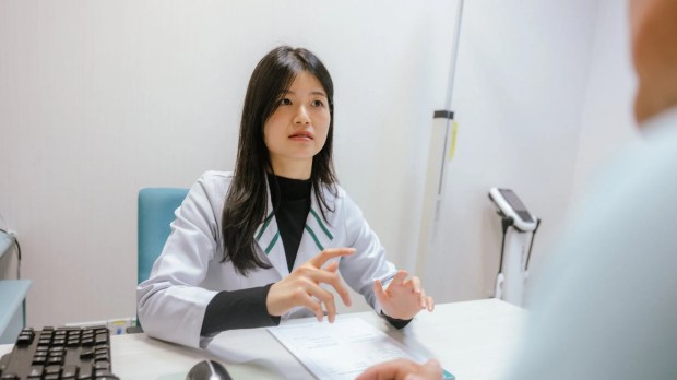 Female doctor consulting with male patient.