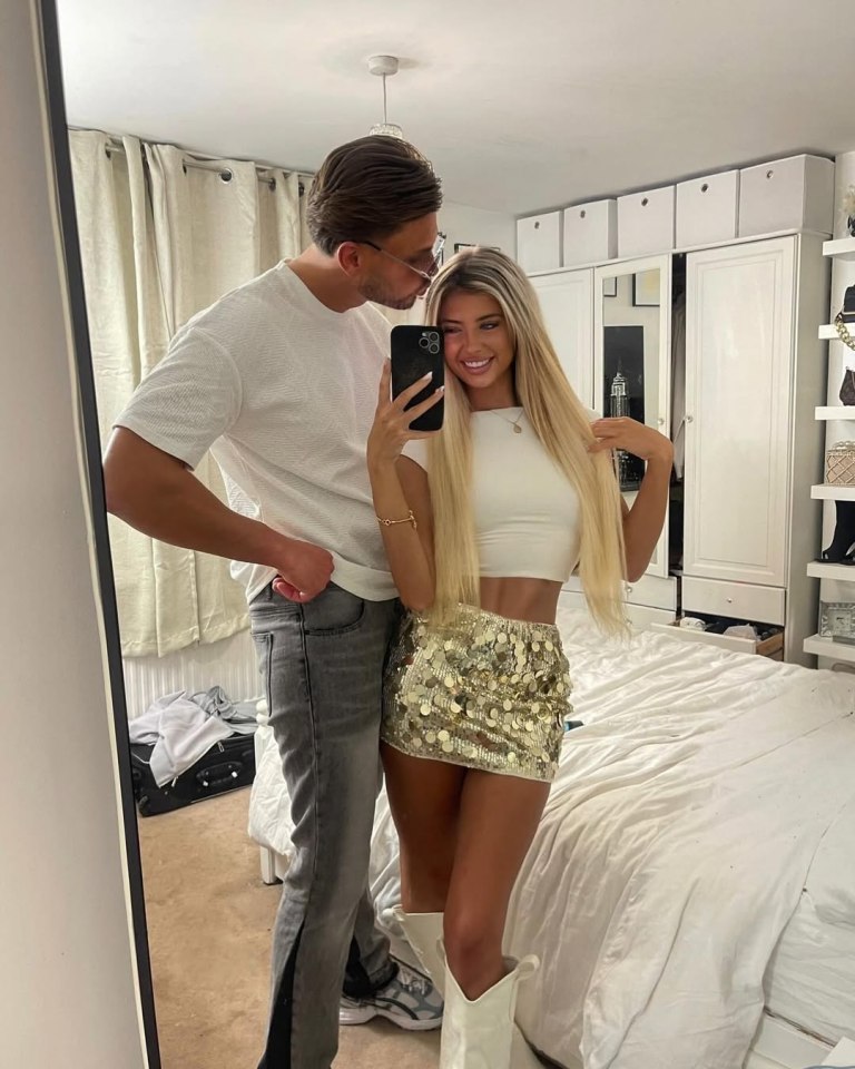 A man and woman taking a selfie.
