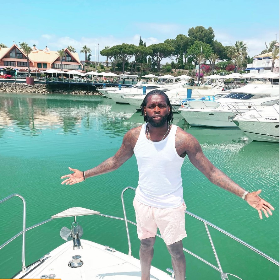 Jay Emmanuel-Thomas on a boat in a marina.