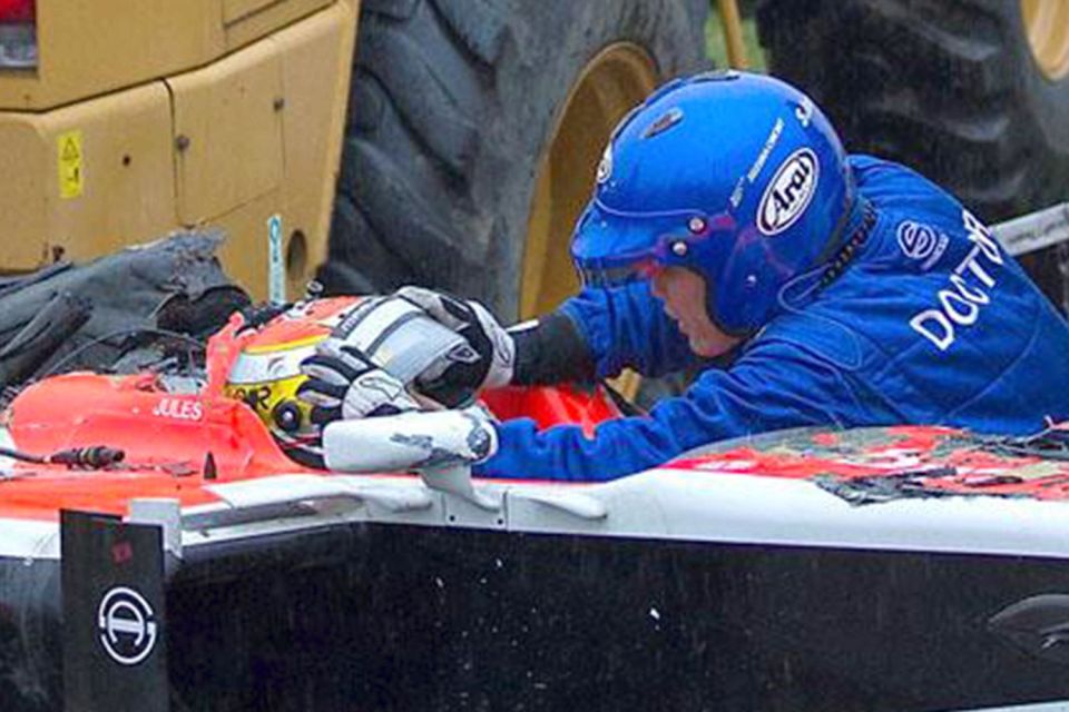 A race doctor tends to Marussia driver Jules Bianchi after horror smash at Japan GP
