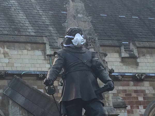 Greenpeace activists clambered up statues across the capital to protest about the capital's air quality