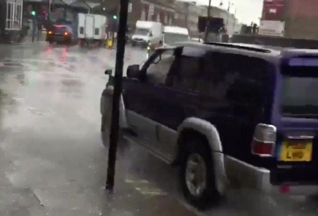The driver appears to pull in near to the kerb in order to drive through puddles and drench people walking by