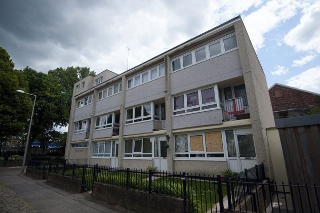 Flat in Edgeley, Gtr Manchester., with its windows boarded up following the sickening ordeal that saw Hasledine burst through them before beating Christopher to death