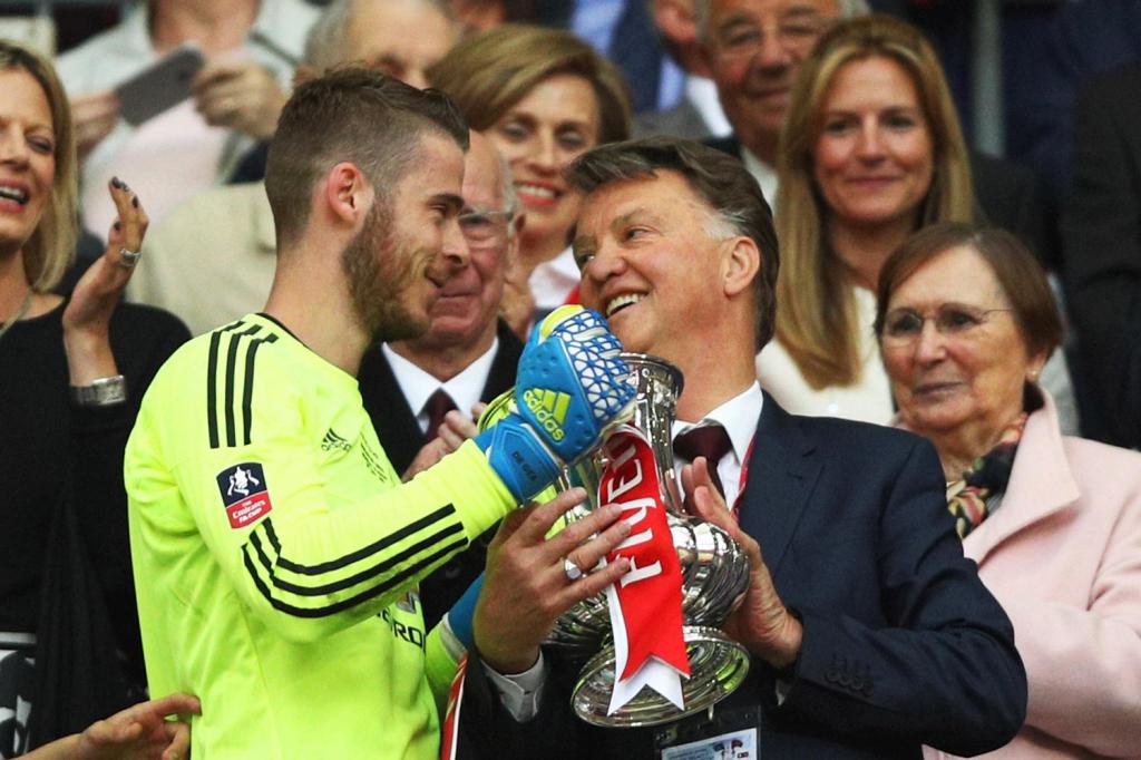 David De Gea hands Louis van Gaal the FA Cup in the Royal Box at Wembley
