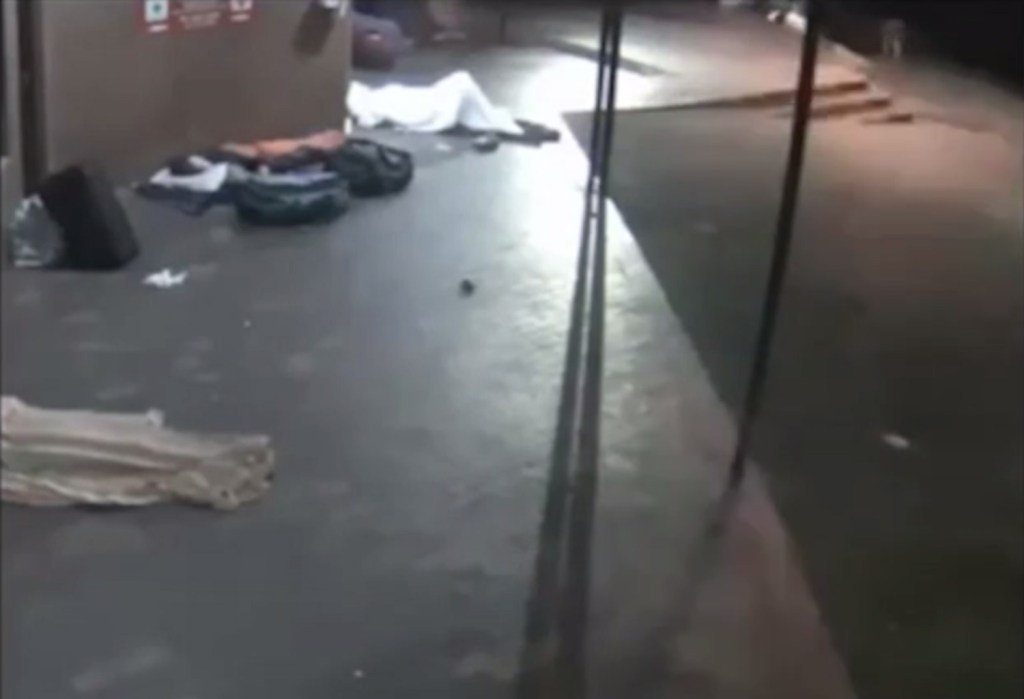 A group of homeless people are trying to sleep at night when a masked assailant started to attack them