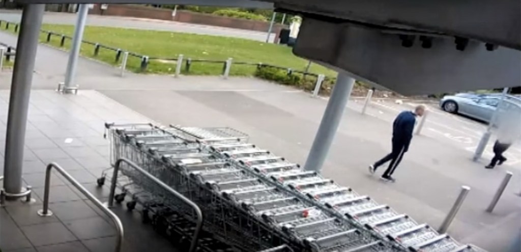 Shortly before the carjacking a man is seen wandering through the Aldi carpark