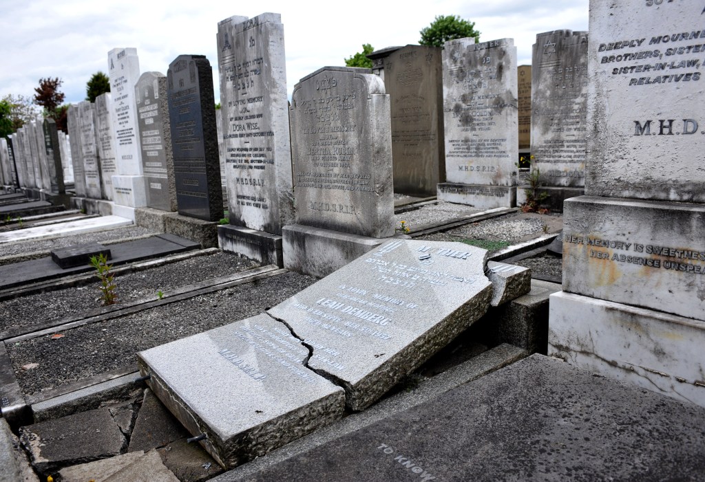 Officers were called to the graveyard at around 3.45 on Wednesday and described the vandalism as racially motivated