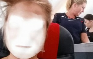 Woman faceswaps with an overhead locker on an aeroplane and it's hilariously creepy